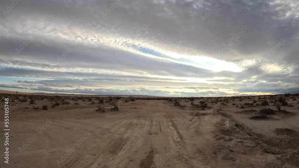 First person view from a person riding a motorcycle along an off-road trail in the Mojave Desert - POV hyper lapse