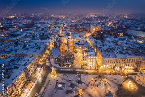 Snow covered old town in Krakow with a view of the Christmas Market photographed in the blue hour. © PawelUchorczak