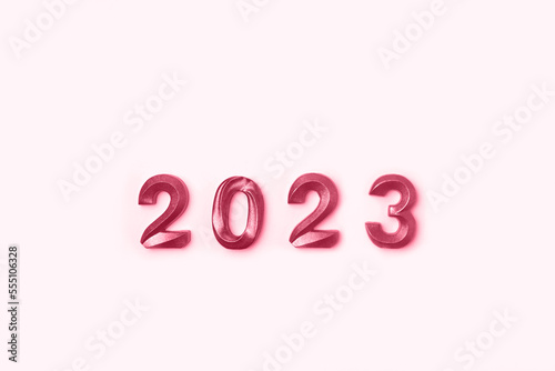 2023 Viva Magenta Colored Numbers on White Table. Modern New Year Background. Creative Greeting Card. Flat Lay, Top View, Copy Space. Banner Design. Minimal Festive Mock Up with Numbers.