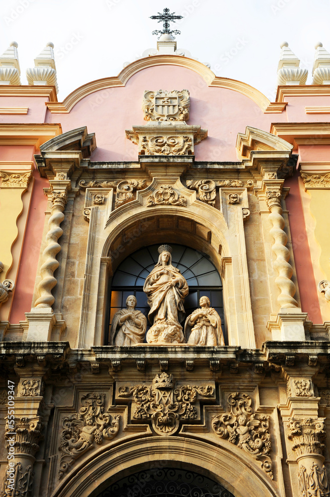 Fototapeta premium Sculptural group with the Virgin Mary on the main facade of the former convent of La Merced, now the Museum of Fine Arts in Seville, Andalusia Spain. Baroque architecture of Seville