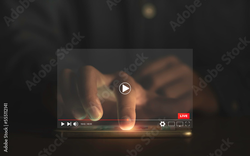 Man touching smartphone to watching and live streaming window for Video streaming on internet and multimedia technology concept. photo