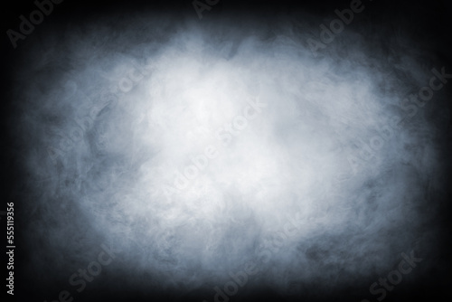 Abstract smoke texture over black. Fog in the darkness.