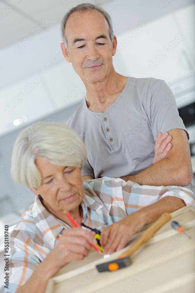 senior couple doing diy together senior couple doing diy together