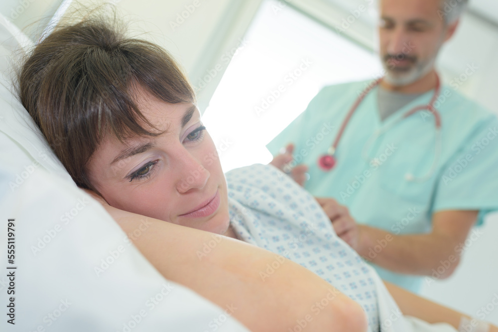 patient looking away as doctor performs procedure on her patient looking away as doctor performs procedure on her