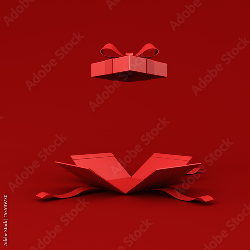 All red opening gift box blank opened present box with red ribbon bow isolated on dark red background for christmas valentines and chinese new year days decorations minimal conceptual 3D rendering