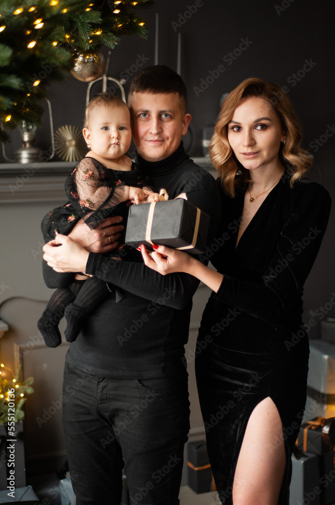 Family portrait. Christmas mood. Dark background Family portrait. Christmas mood. Dark background