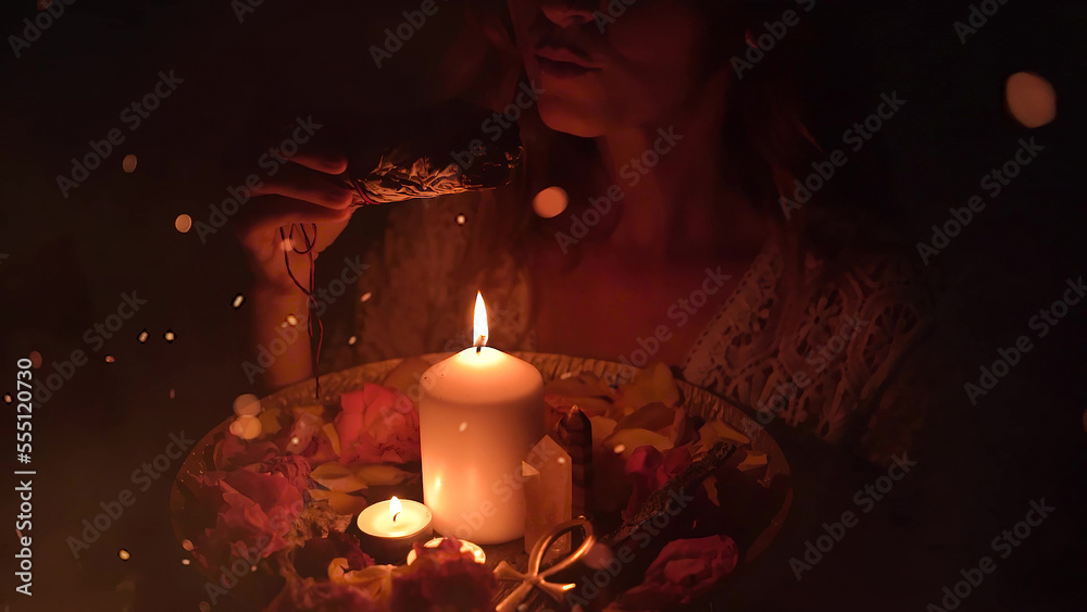 incense in a woman hand, incense smoke on a black background. incense in a woman hand, incense smoke on a black background.