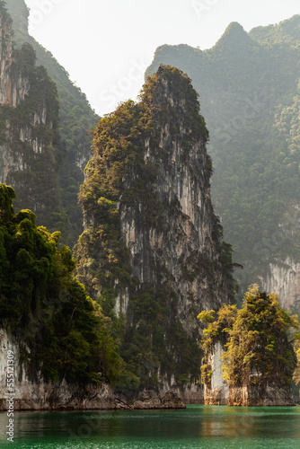 Landscape of karst mountains, covered with rainforest and vegetation at Cheow Lan Lake, inside Khao Sok National Park, Thailand photo