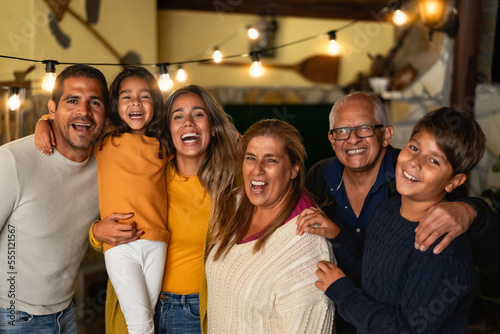 Happy Hispanic family enjoying holidays together at home