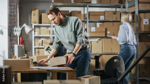 Multicultural Team of Warehouse Employees at Work in Retail Shop's Storeroom. Small Business Owners and Inventory Managers Working on Laptop, Packing Parcels for Delivery.