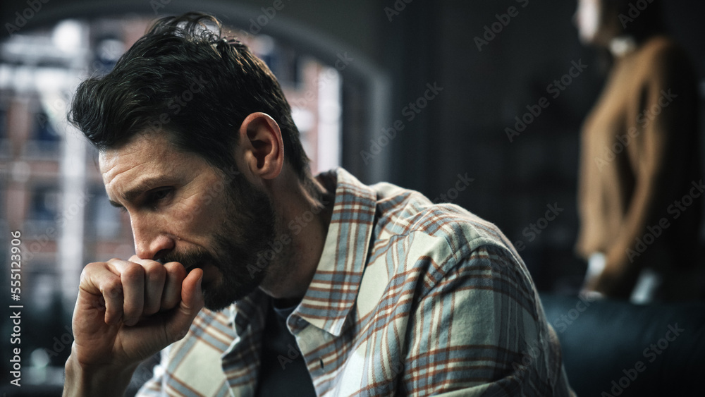 Portrait of Fragile Crying Man being Harrased and Bullied by Partner. Couple Arguing and Fighting Violently. Domestic Violence, Emotional Abuse, Toxic Behavior. Rack Focus with Girfriend Screaming