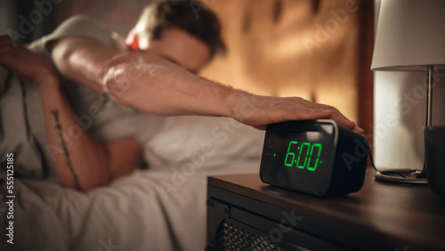 Tableau sur toile Man Wakes Up and Turns off Alarm Clock