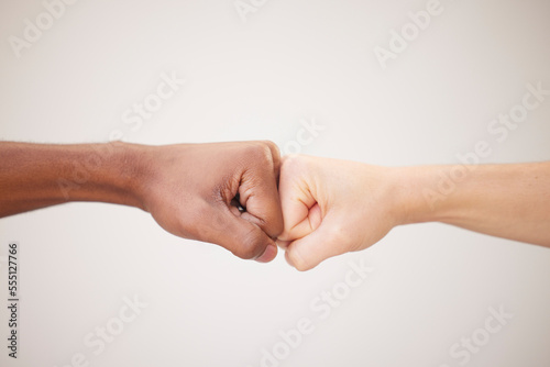 Fist bump, support and hands of people or friends together for justice, freedom and diversity with trust, collaboration and motivation on white background. Men together for power at peace protest © Lune V A/peopleimages.com