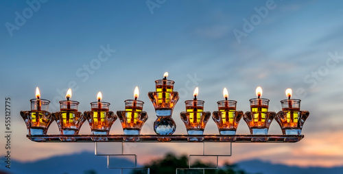Crystal festive menorah and burning candles with olive oil as symbol of Hanuk...