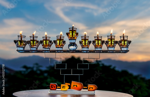 Festive donut, menorah, candles, dreidels - traditional symbols of Hanukkah H...