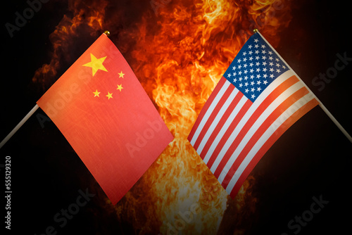 Flags of China and United States of america against background of a fiery explosion. The concept of enmity and war between countries. Tense political relations.
