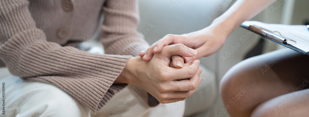 Fototapeta premium Young woman in a mental therapy session talking with a psychologist in the office.