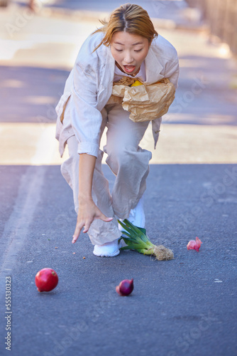 Konstfotografi Drop, accident and woman with groceries in the street, clumsy and trip while walking with shopping bag in the city of Japan