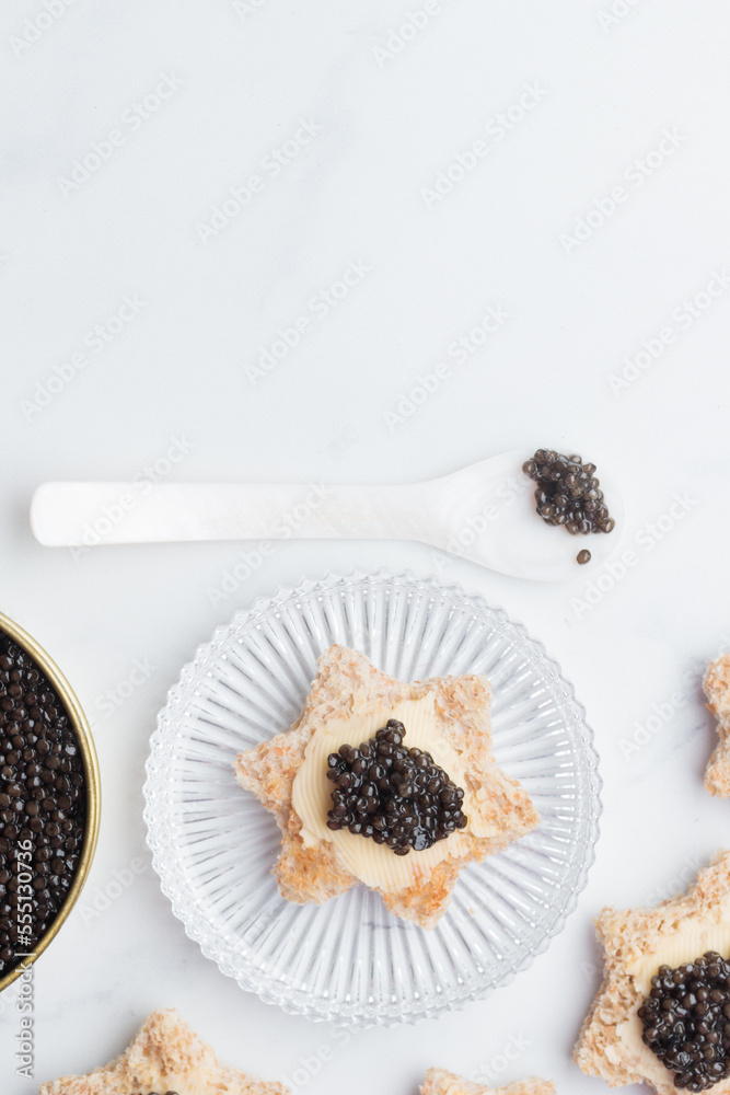 Black caviar appetizers bread star on a white background top view Black caviar appetizers bread star on a white background top view