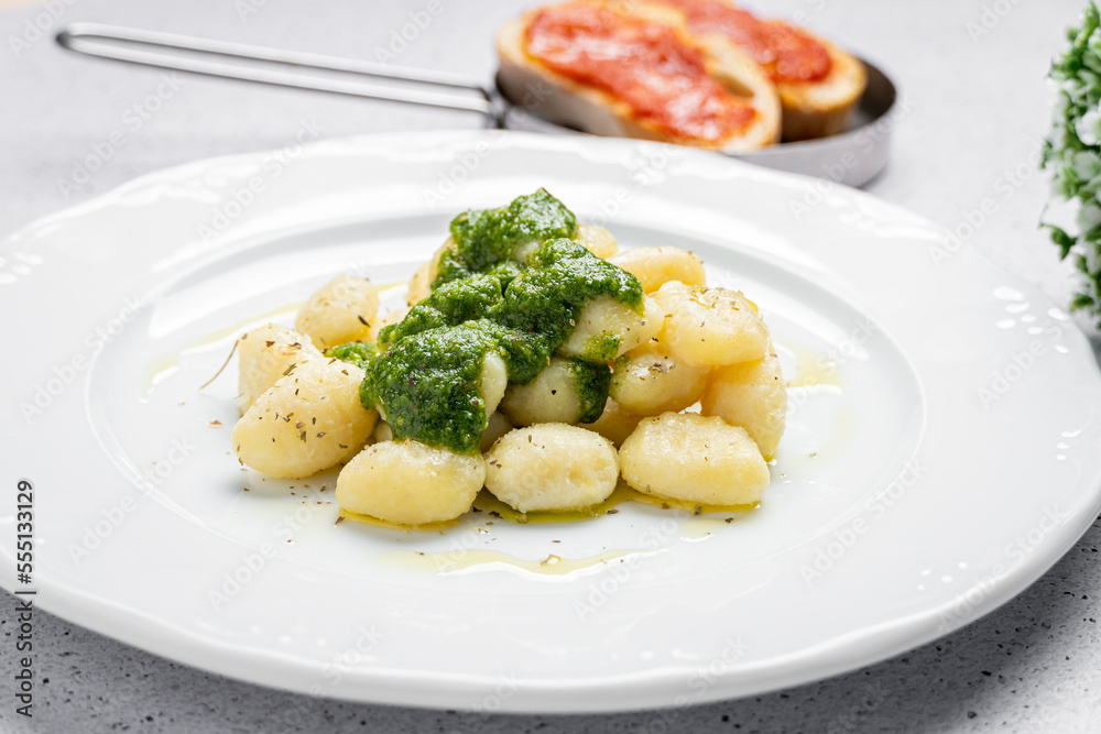 Delicious gnocchi with pesto sauce on plate Delicious gnocchi with pesto sauce on plate