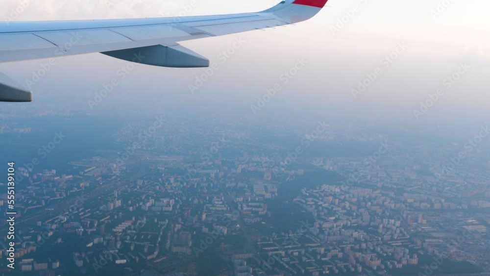 View from the airplane porthole on the wing and horizon, blue sky. Travel and tourism concept. Comfortable flight View from the airplane porthole on the wing and horizon, blue sky. Travel and tourism concept. Comfortable flight