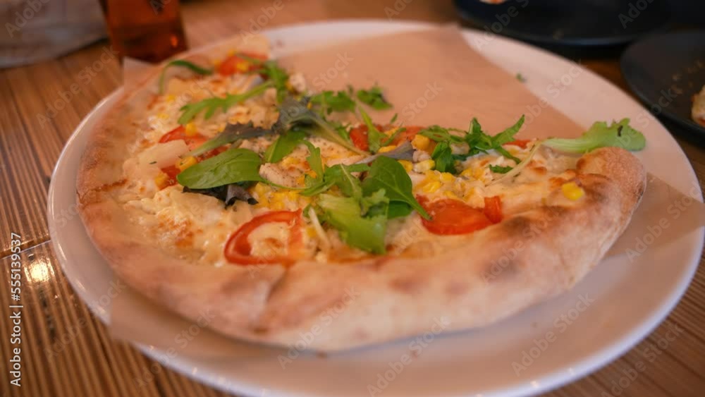 People eat delicious pizza in a cafe People eat delicious pizza in a cafe