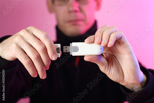 gsm modem in the fingers of a person's hand in a black sweatshirt © Wojciech Boruch