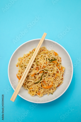 Fresh tasty noodles with vegetables in white bowl