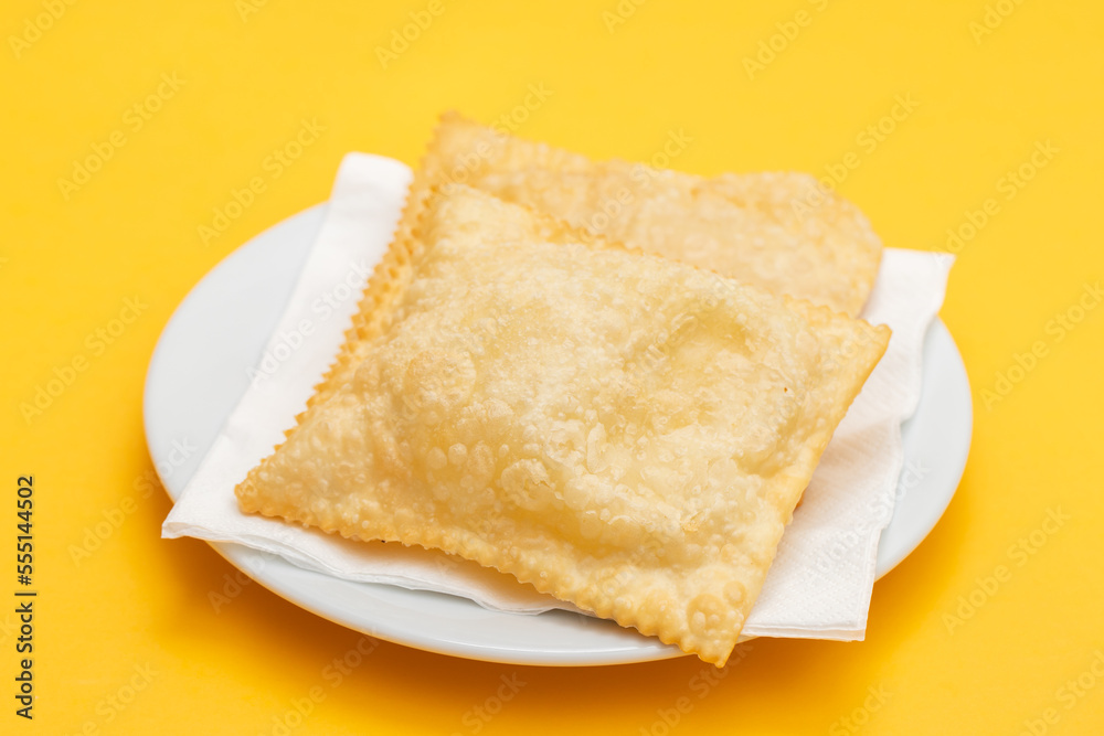 typical brazilian fried pastry on white plate