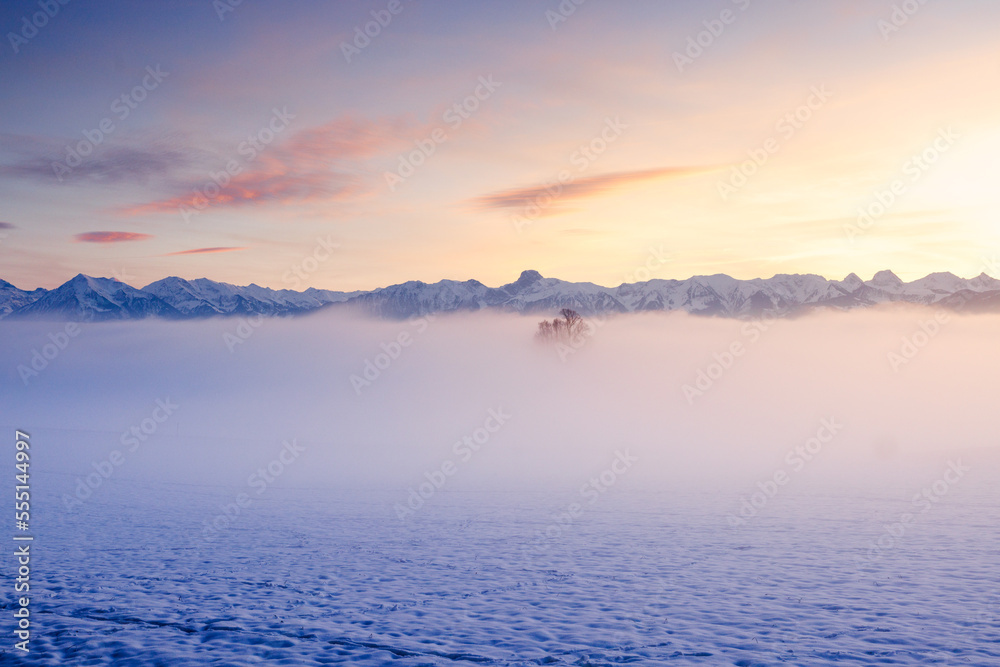 misty sunset with Stockhorn ridge in the distance