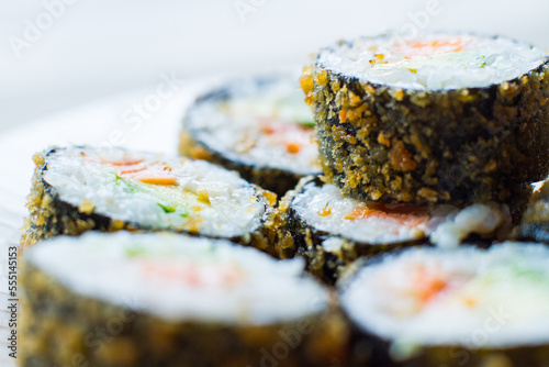 Hot roll fried  Sushi Roll with Salmon and Vegetables. Modern sushi recipe in Japan. photo