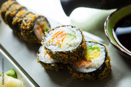 Hot roll fried  Sushi Roll with Salmon and Vegetables. Modern sushi recipe in Japan. photo