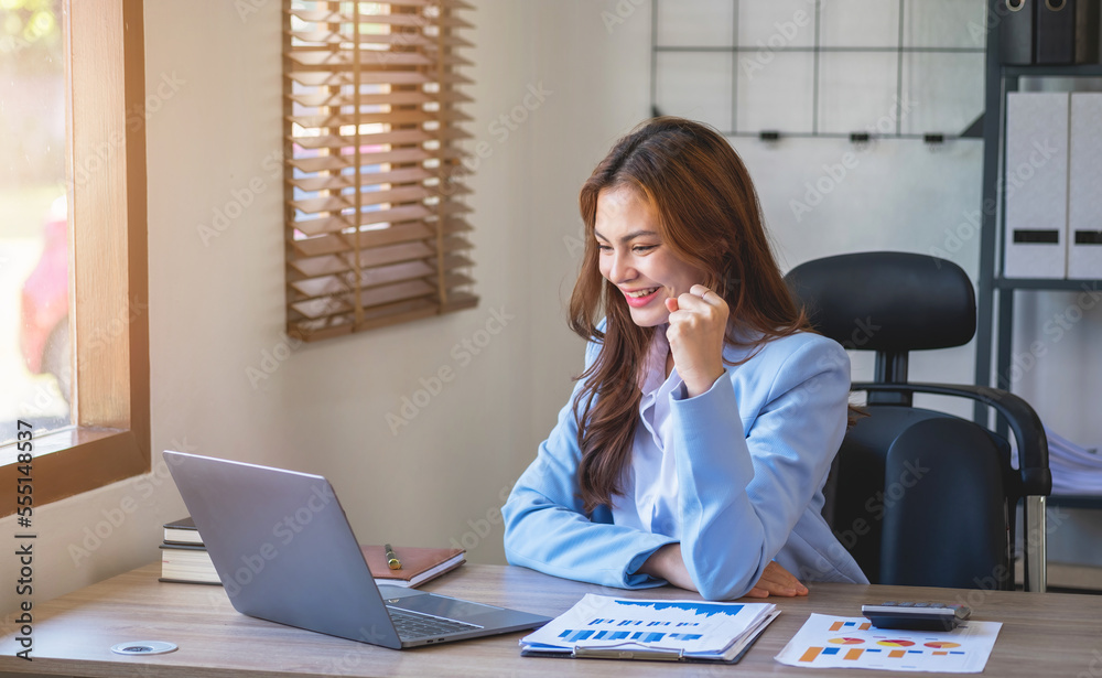 Marketing, Financial, Accounting, Planning, Asian businesswoman team leader with beautiful leaves smiles showing joy after successful company work. Marketing, Financial, Accounting, Planning, Asian businesswoman team leader with beautiful leaves smiles showing joy after successful company work.