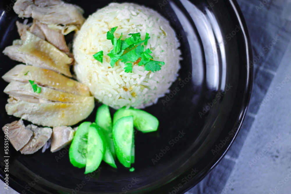Hainanese chicken rice with soup or steamed chicken and sauces. Hainanese chicken rice with soup or steamed chicken and sauces.