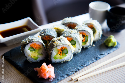 Vegan sushi hot roll. Sushi roll filled with vegetables and fried. photo