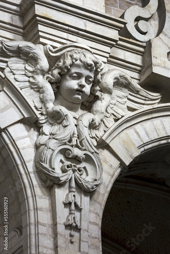 Decorative angel sculpture on a building with arches; Brussels, Belgium