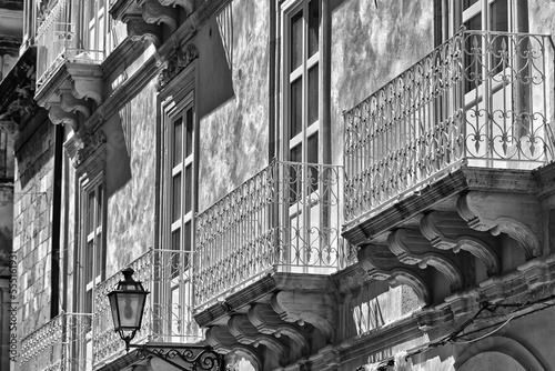 Facade of a residential building with balconies and decorative facade; Syracuse, Sicily, Ortigia, Italy photo