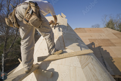 Carpenter working on the turret of a house photo