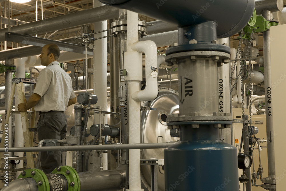 Engineer with air compressors in water treatment plant Engineer with air compressors in water treatment plant