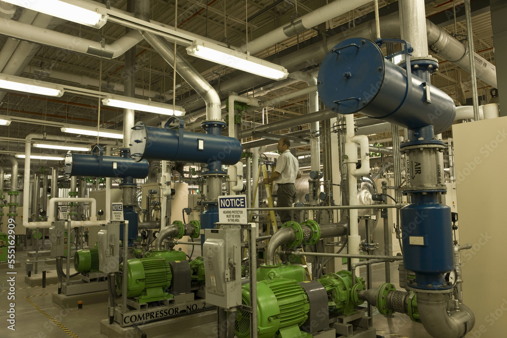 Engineer with air compressors in water treatment plant Engineer with air compressors in water treatment plant