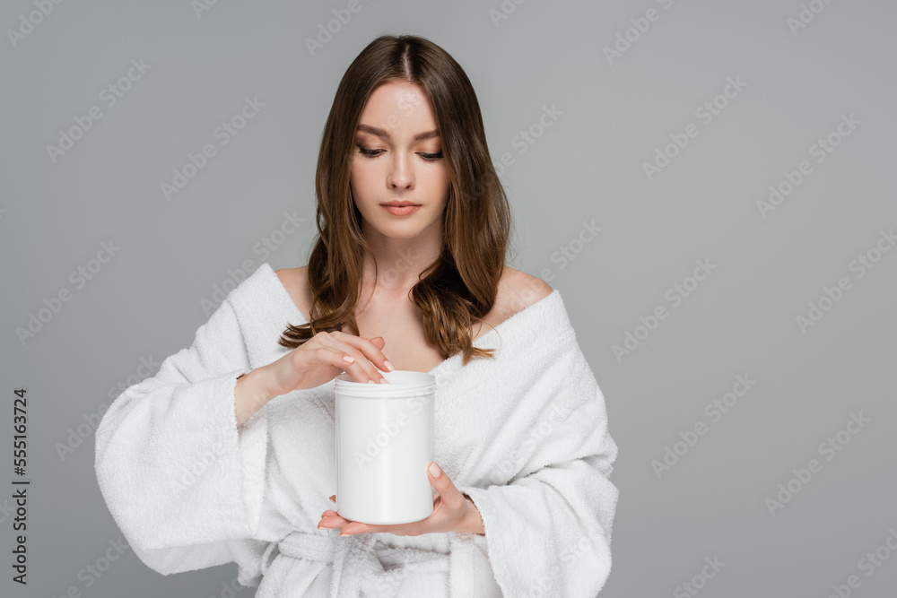 young woman with shiny hair holding container with treatment mask isolated on grey young woman with shiny hair holding container with treatment mask isolated on grey