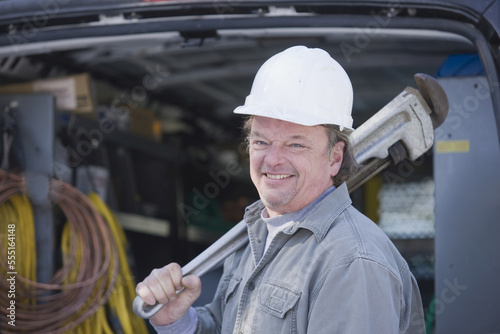 Plumber holding a pipe wrench photo