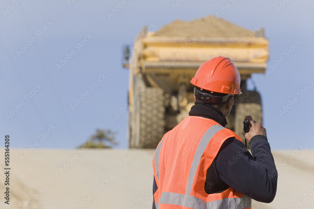 Engineer talking on a walkie-talkie Engineer talking on a walkie-talkie