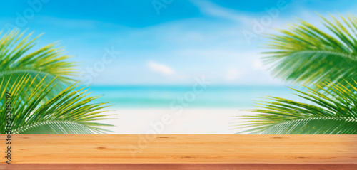 Fototapeta Naklejka Na Ścianę i Meble -  Top wood table and palm tree and tropical beach background.Empty ready for your product display montage.