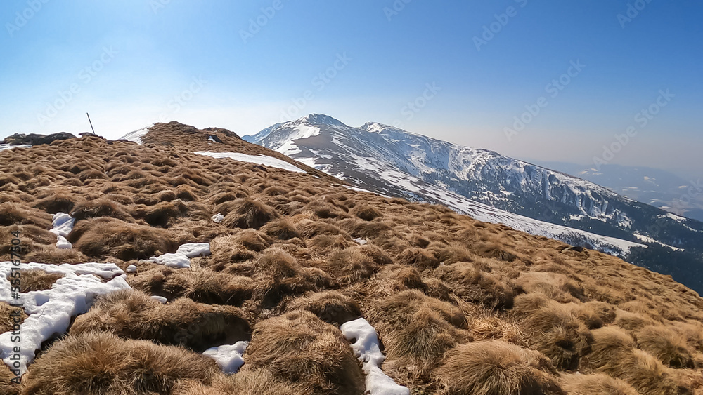 Panoramic aerial view from Schusterleiten of snow capped mountain peaks of Zirbitzkogel and Kreiskogel, Seetal Alps, Styria (Steiermark), Austria, Europe. Idyllic hiking trail in sunny early spring Panoramic aerial view from Schusterleiten of snow capped mountain peaks of Zirbitzkogel and Kreiskogel, Seetal Alps, Styria (Steiermark), Austria, Europe. Idyllic hiking trail in sunny early spring