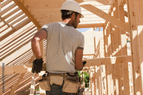 Carpenter holding a wooden stud