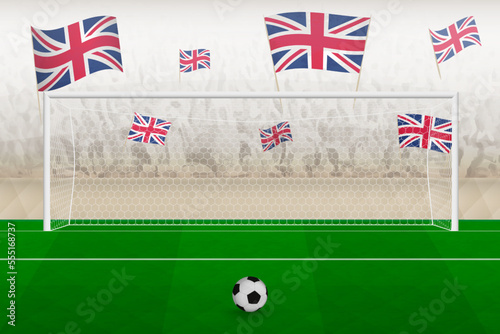 United Kingdom football team fans with flags of United Kingdom cheering on stadium, penalty kick concept in a soccer match.