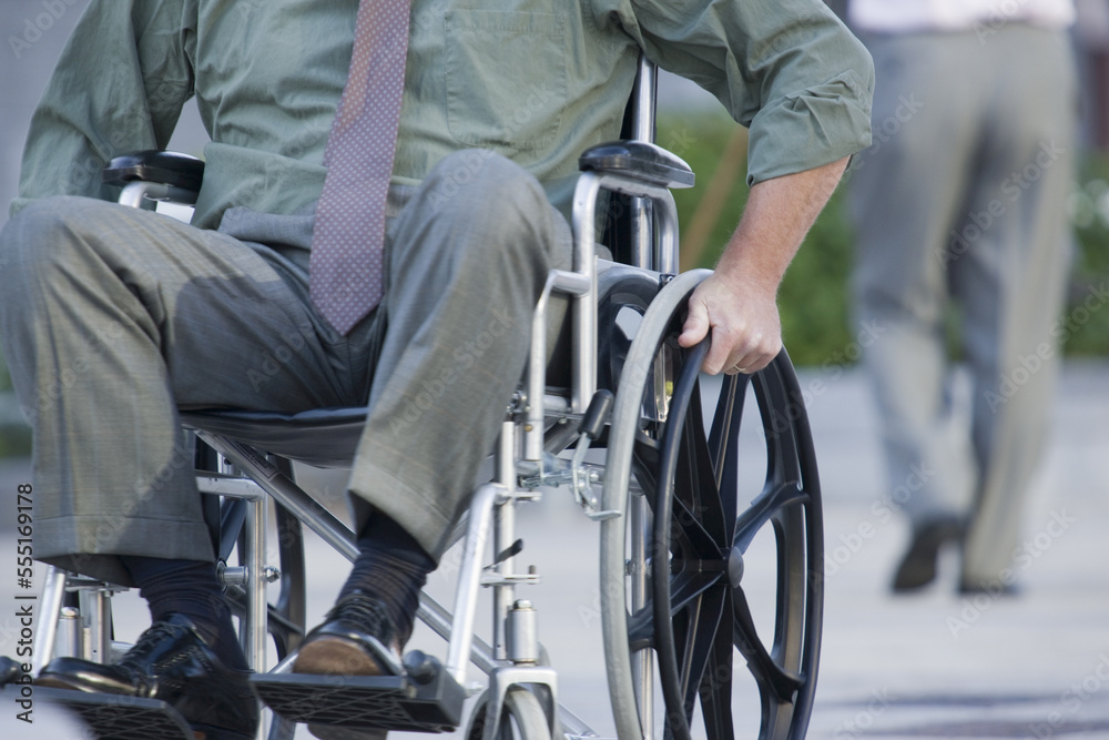 Businessman on wheelchair, low section Businessman on wheelchair, low section