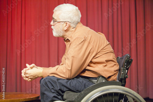 Man with muscular dystrophy and diabetes in a TV studio as a commentator photo