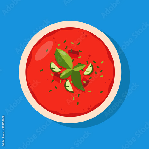 Gazpacho made of raw, blended vegetables. Cold soup on blue background.